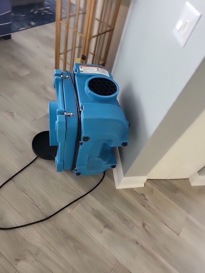 HEPA air scrubber running in living room during water damage restoration